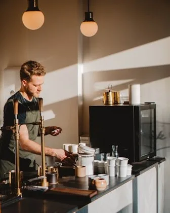 Barista serving a cafe counter